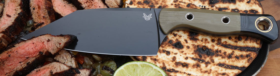 Benchmade Station Knife with OD Green G10 handle resting on a platter of sliced grilled flank steak, lime, and charred flour tortilla