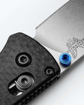Benchmade Bugout® Carbon Fiber Handle Detail - Blue Thumb Stud Close-up | Benchmade Knife Co.