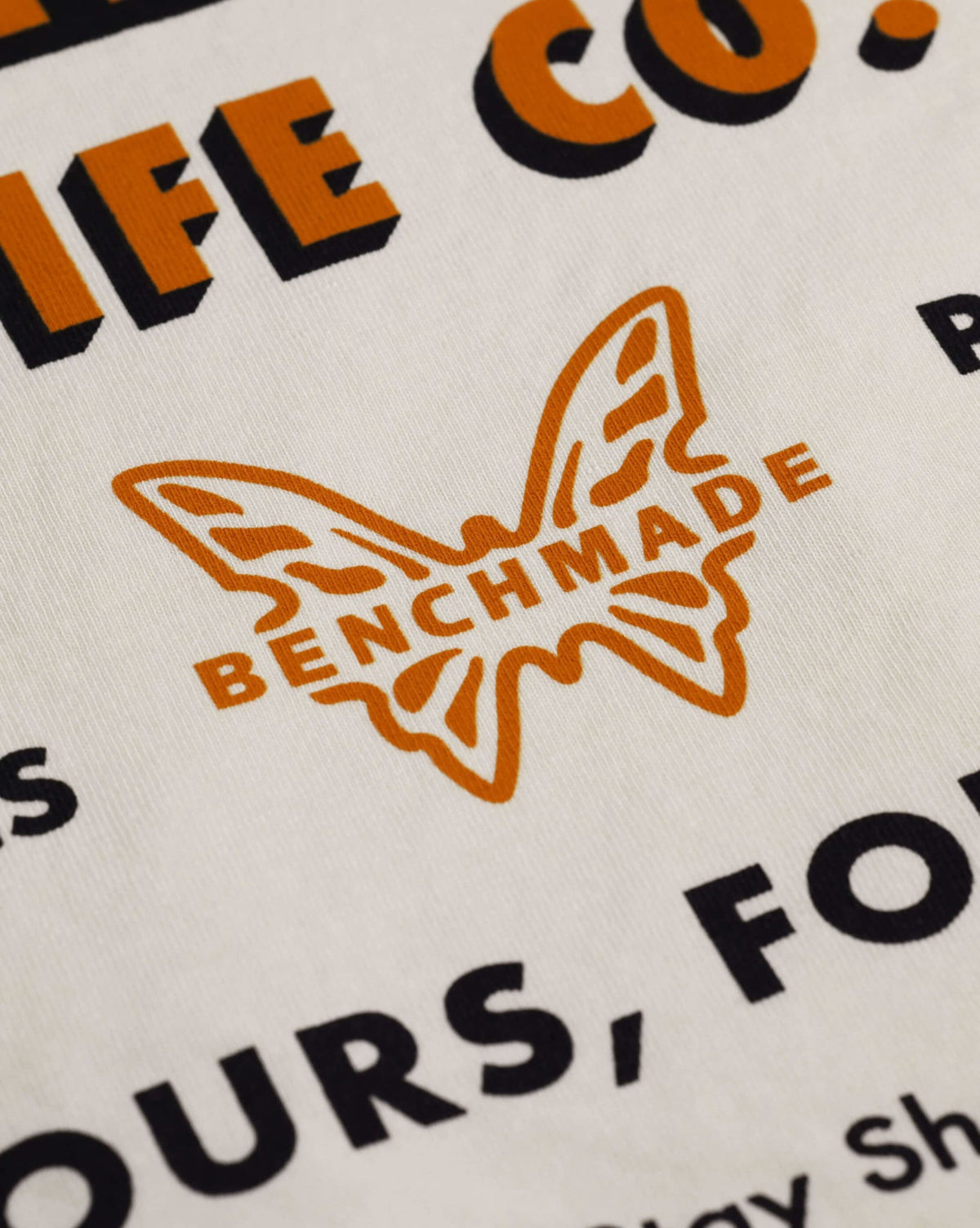 Orange Benchmade Butterfly Logo Detail - Back Graphic Close-up | Benchmade Knife Co.
