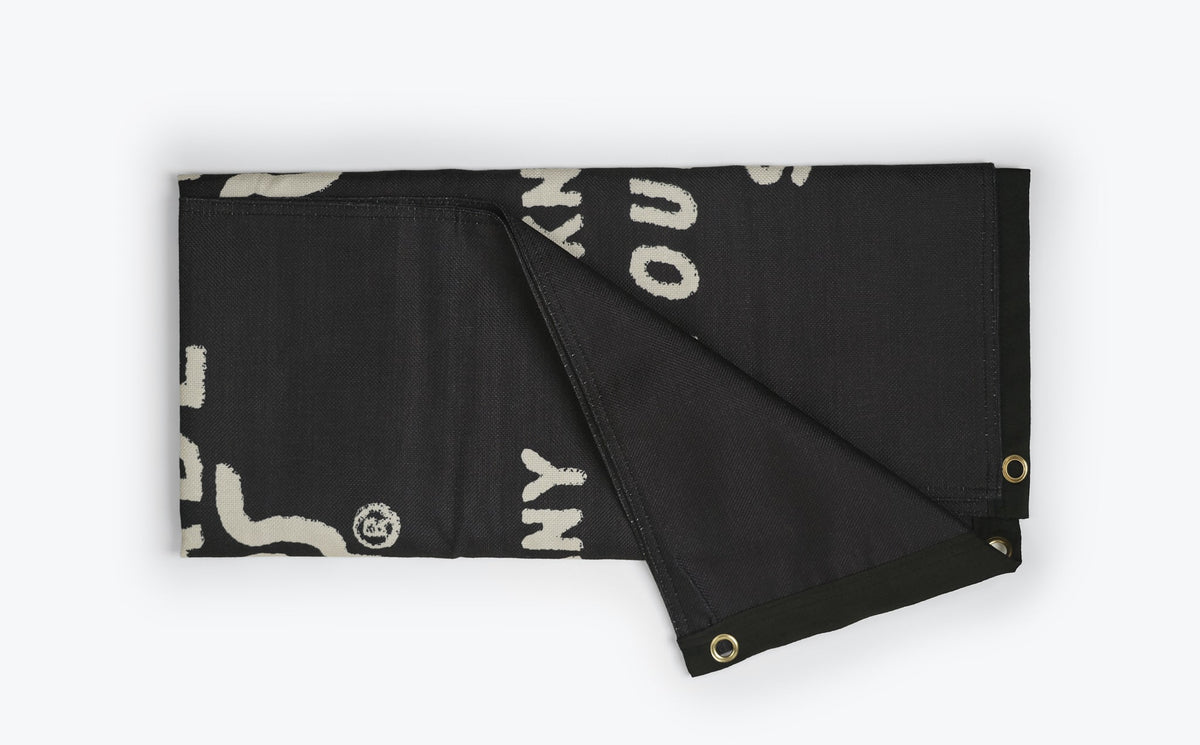 Benchmade Logo Garage Banner folded showing back side with brass eyelets | Benchmade Knife Co.