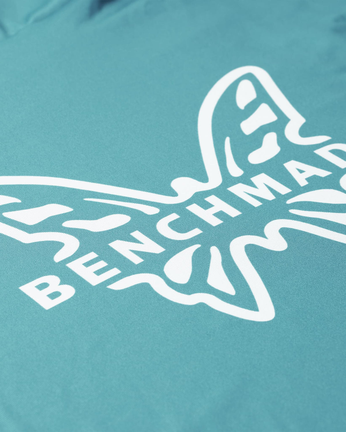 Depth Blue Benchmade Butterfly Sun Hoodie - Angled Logo Close-Up, Polyester Spandex Fabric | Benchmade Knife Co.